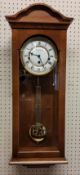 A Fox & Simpson golden oak finish wall clock, 8 day movement, 4/4 chime, automatic night shut off,