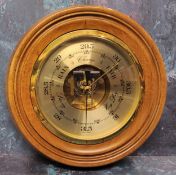 A German large circular walnut aneroid barometer 25.5cms dia. NOS in original packaging