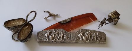 A Dutch silver comb cover embossed in relief with a village scene stamped Denmark and dolphin