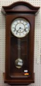 A Hermle Regulator Wall Clock, mahogany finish, 8 Day Movement 4/4 Westminister chime, pendulum, key