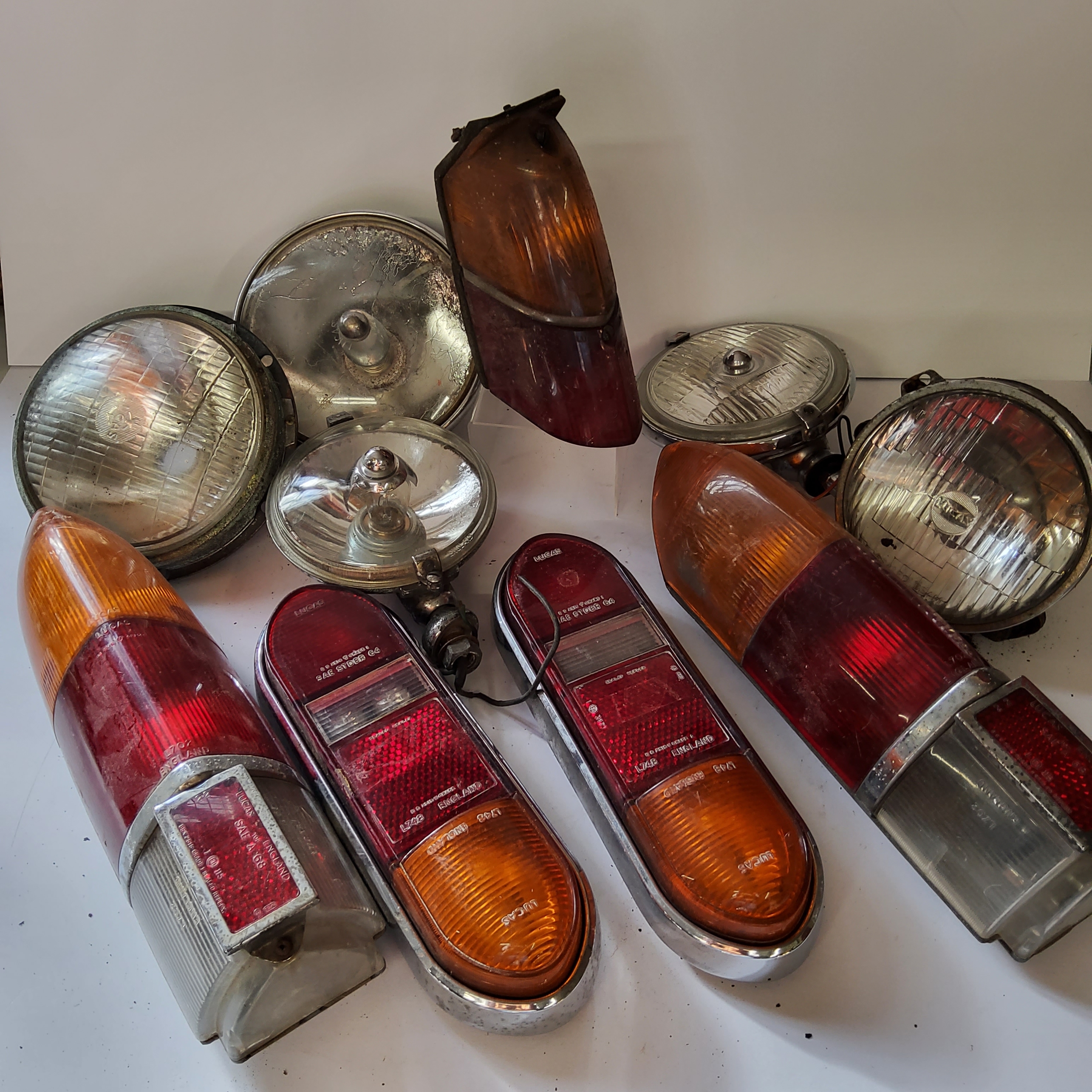 Classic car restoration parts including Lucas tail lights model no.' SAE A 68', Lucas halogen