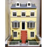A large 'Georgian' doll's house;  a large quantity of dolls house furniture and accessories