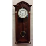 A Hermle Regulator Wall Clock, mahogany finish, 8 Day Movement 4/4 Westminister chime, pendulum, key