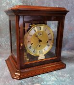 A 20th century mantel clock by Franz Hermle & Sohn serial number 352-073 K5, the four glass case