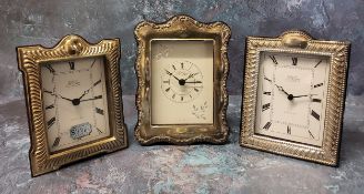 Two silver mounted miniature clocks in form of mantel clocks, silver panels to front, a vacant