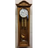 A Hermle oak finish regulator wall clock with 1/2 hour strike, 8 day cable driven movement, white