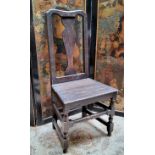 An 18th century English oak hall chair