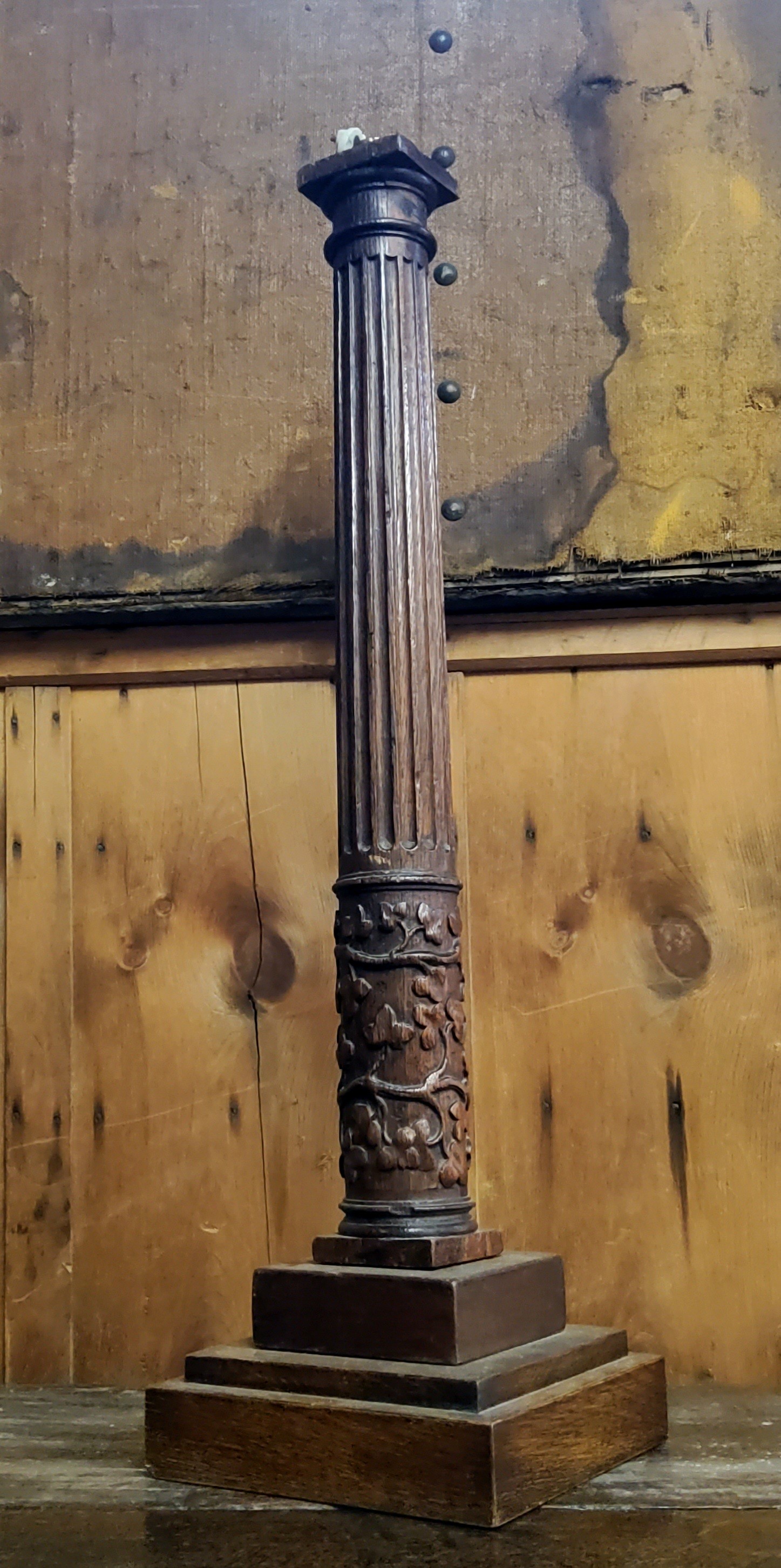 A substantial Charles II period English oak table lamp base, profusely carved with oak leafs towards