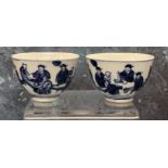 Two Chinese  wine bowls, decorated in blue with figures in various poses, 6.5cm diam, four character