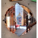 A substantial Art Deco shaped circular mirror, with peach coloured glass to the quarters,