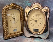 A silver mounted shaped mantel clock, embossed in relief decoration, Ron Carr, Sheffield, 2000;