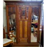 A Victorian burr walnut and mahogany double wardrobe, the oversailing cornice above central blind