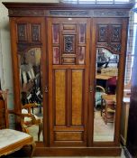 A Victorian burr walnut and mahogany double wardrobe, the oversailing cornice above central blind