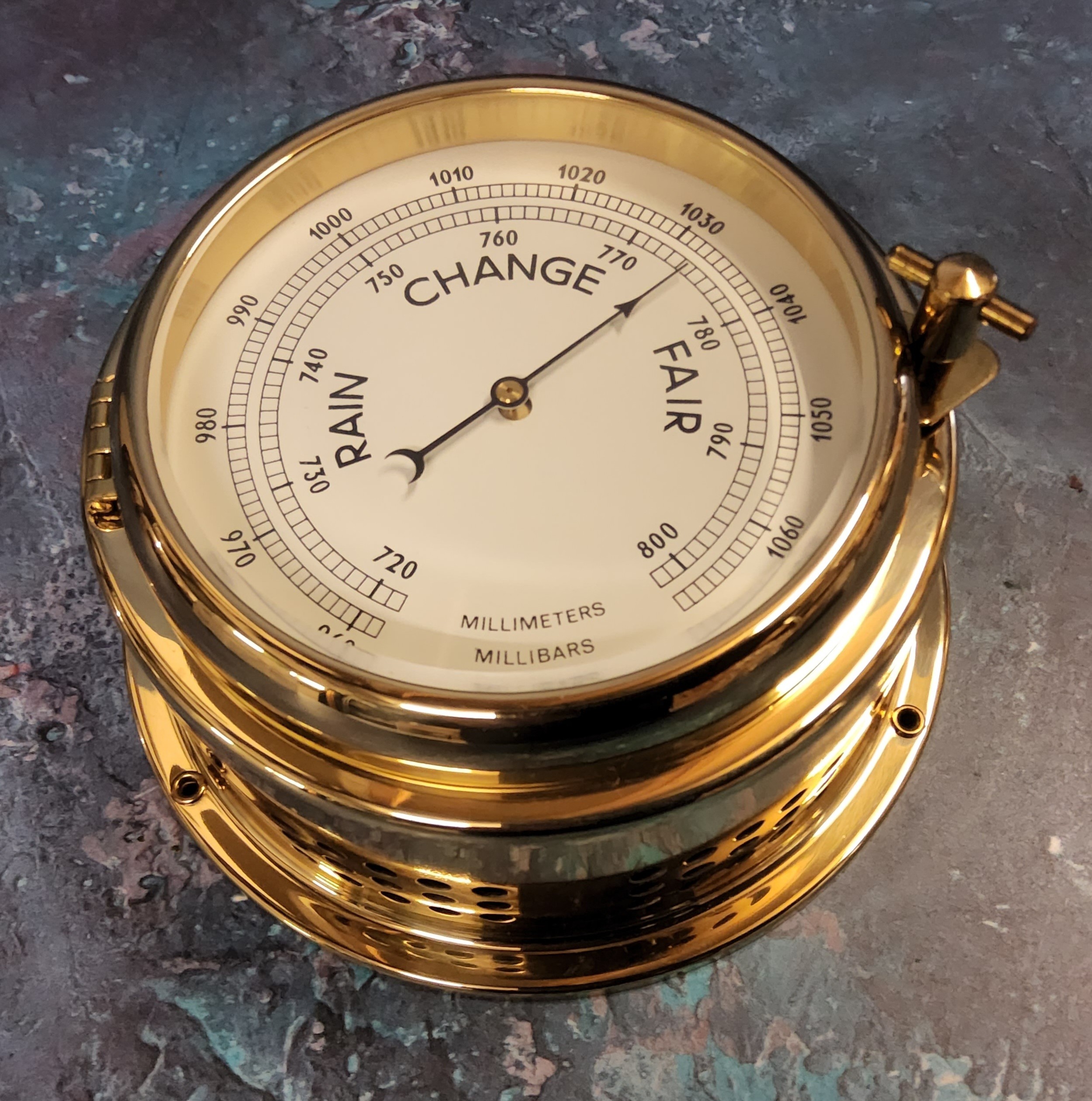 A German brass porthole barometer, screw down hinged cover 14cm dia. 8cm h, NOS papers & packaging