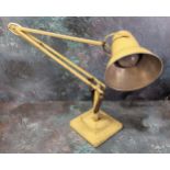A Herbert Terry Anglepoise lamp - an early example finished in cream, weighted plinth base.