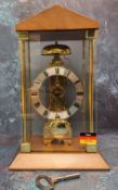 A contemporary Hermle skeleton mantel clock, mechanical hour strike movement and automatic anchor,