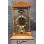 A contemporary Hermle skeleton mantel clock, mechanical hour strike movement and automatic anchor,