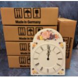 A decorative pressed metal wall clock, quartz, in the form of a grandfather clock dial, quartz