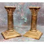 A pair of silver Corinthian column candlesticks, stoop fluted columns, stepped bases, 15.5cm high,