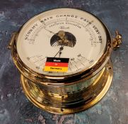 A Franz Hermle Brass Percision Barometer,  in the style of a ships port hole, NOS, with original