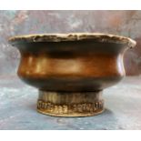 A Tibetan white metal mounted indigenous timber circular libation bowl, raised foot ring, 10cm diam