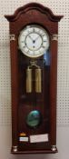 A Hermle Regulator Wall Clock, mahogany finish, 8 Day Movement 4/4 Westminister chime, weights,