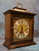 A 20th century mahogany bracket clock, Indian mask foliate scroll spandrels, Roman numerals, three