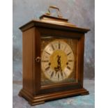 A 20th century mahogany bracket clock, Indian mask foliate scroll spandrels, Roman numerals, three