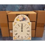 A decorative pressed metal wall clock, quartz, in the form of a grandfather clock dial, quartz