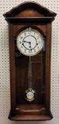 A Hermle wall clock, 8-day mechanical strike 4/4 Westminster movement, walnut and burl wood