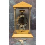 A contemporary Hermle skeleton mantel clock, mechanical hour strike movement and automatic anchor,