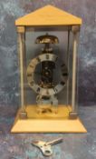 A contemporary Hermle skeleton mantel clock, mechanical hour strike movement and automatic anchor,