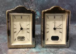 Two silver mounted miniature alarm clocks in form of shaped mantel clocks, silver panels to front,