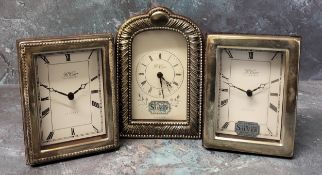 Two silver mounted miniature clocks in form of mantel clocks, silver panels to front, a vacant panel