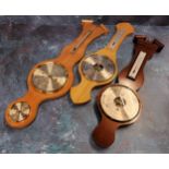 A Woodford mahogany banjo barometer in original packaging; another oak loose; a satinwood banjo