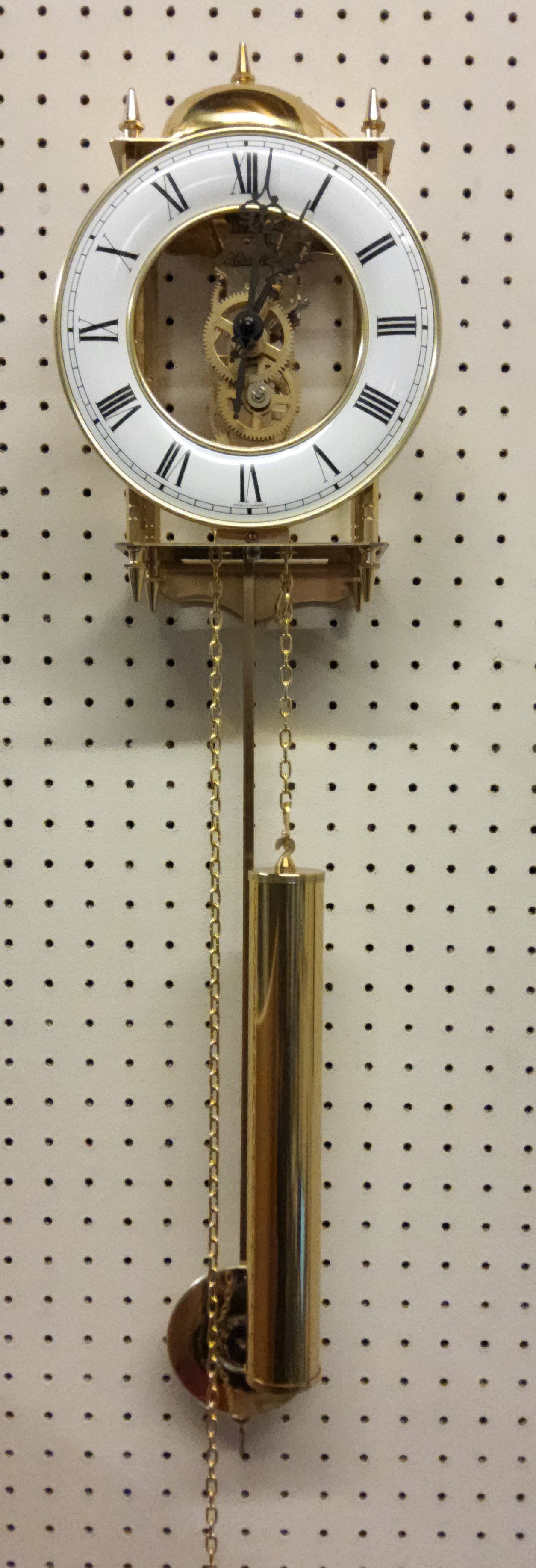 A Franz Hermle brass skeleton wall clock, 8-day chain-driven skeleton movement with a pendulum,