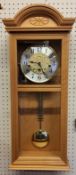 A Hermle Regulator Wall Clock, Beech finish, 8 Day Movement 4/4 Westminister chime, pendulum, key