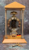 A contemporary Hermle skeleton mantel clock, 14-day mechanical movement with hourly chime on bell,