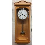 A contemporary Hermle light Beech finish wall clock, 8-day movement, single strike gong, pendulum,