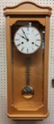 A contemporary Hermle light Beech finish wall clock, 8-day movement, single strike gong, pendulum,