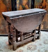 A 17th century English oak bobbin turned drop leaf tavern table c.1660