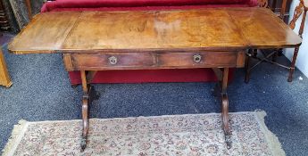 A Regency type sofa table, two short drawers to frieze, brass lion paw feet