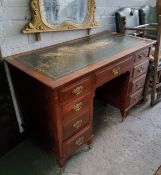 A Victorian mahogany kneehole desk, tooled green leather inlay, brass batwing escutcheons with