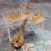 A Continental white metal miniature of a man playing street ninepins on a rectangular base