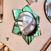 An Art Deco emerald green glass flower head mirror, with convex or 'fish eye' looking glass, 58cm