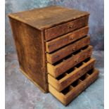 An early 20th century watchmaker's or collector's bank of six graduated pine drawers, 35cm high x