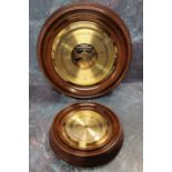 A circular brass barometer, mahogany mount, twin diaphragm, the brass dial marked Russell of