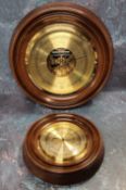 A circular brass barometer, mahogany mount, twin diaphragm, the brass dial marked Russell of
