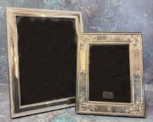 A silver mounted picture frame, embossed in relief border, wood backed,23.5cms high, Ron Carr,