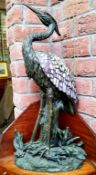A large Tiffany style table lamp in the form of a heron, Verdigris effect base with amethyst